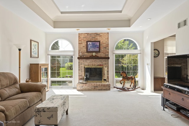 36225 N Goldspring Ct, Gurnee, IL 60031 - living area featuring a brick fireplace, carpet flooring, and a tray ceiling