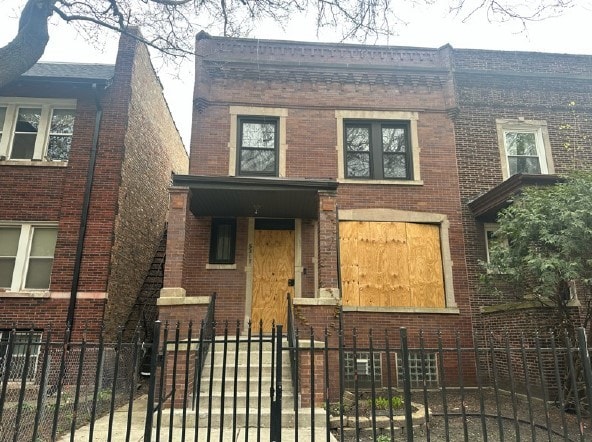 5217 S Ingleside Ave, Chicago, IL 60615 - view of front of home featuring brick siding and a fenced front yard