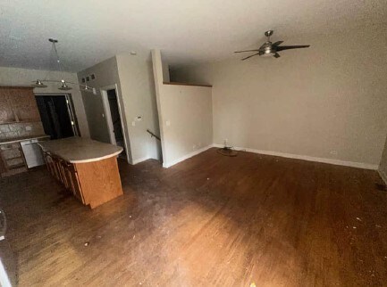 5217 S Ingleside Ave, Chicago, IL 60615 - unfurnished living room featuring baseboards, ceiling fan, and wood finished floors