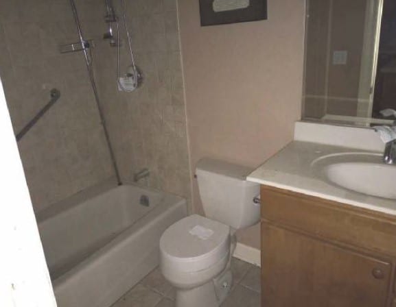 5217 S Ingleside Ave, Chicago, IL 60615 - bathroom with vanity, tile patterned flooring, bathtub / shower combination, and toilet