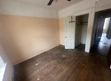 5217 S Ingleside Ave, Chicago, IL 60615 - unfurnished bedroom with a closet, dark wood-style flooring, ceiling fan, and baseboards