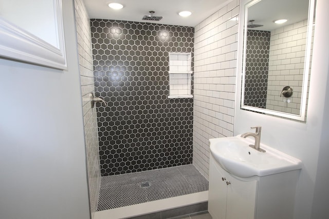 full bath featuring vanity, recessed lighting, and a tile shower