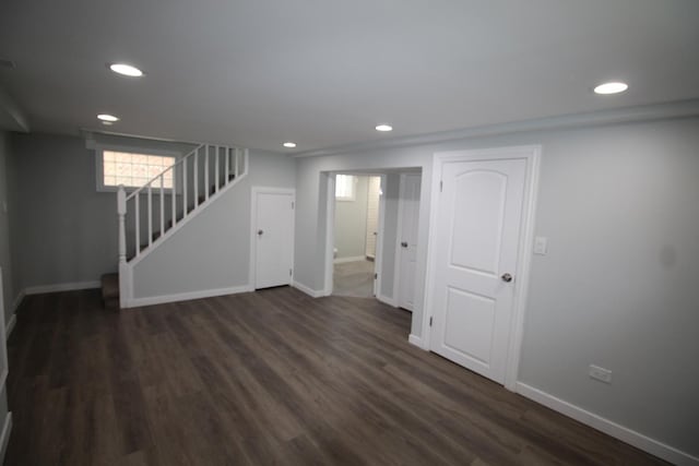 basement with stairway, baseboards, recessed lighting, and dark wood-style floors