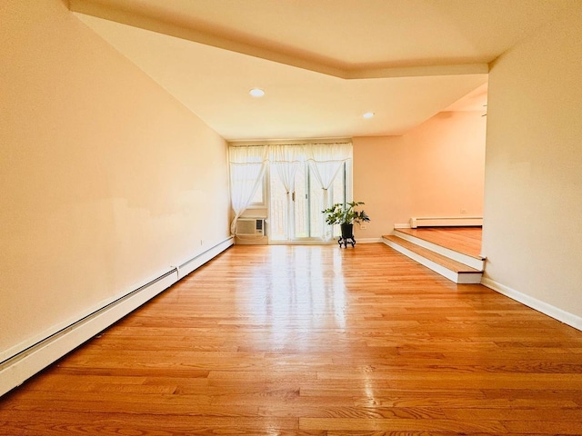 spare room with recessed lighting, baseboards, baseboard heating, and wood finished floors