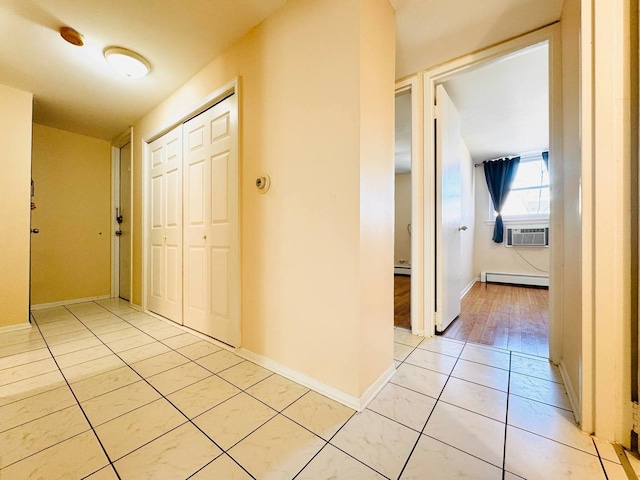 hall featuring baseboards, a baseboard radiator, cooling unit, and light tile patterned flooring