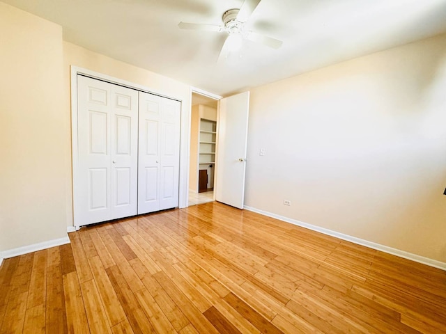 unfurnished bedroom featuring baseboards, a closet, and light wood-style flooring
