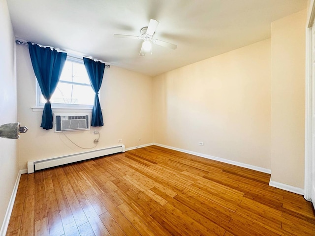 spare room featuring ceiling fan, baseboard heating, cooling unit, baseboards, and hardwood / wood-style flooring