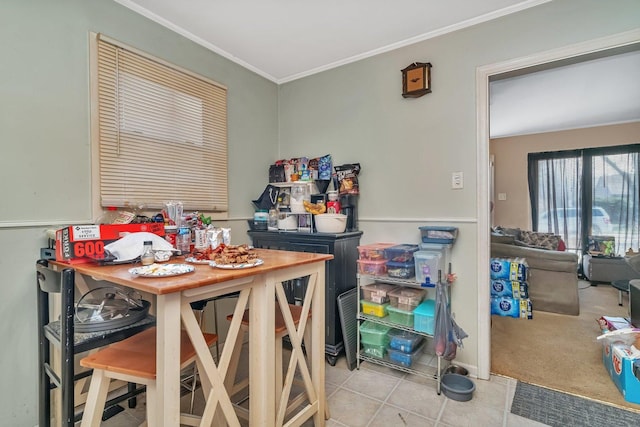 dining room featuring ornamental molding and tile patterned floors