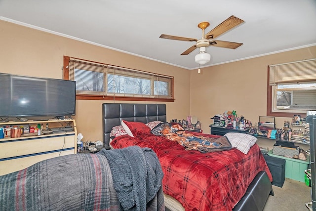 bedroom featuring crown molding, carpet flooring, ceiling fan, and multiple windows