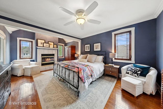 9606 S Vanderpoel Ave, Chicago, IL 60643 - bedroom with hardwood / wood-style floors, multiple windows, crown molding, a tile fireplace, and a ceiling fan