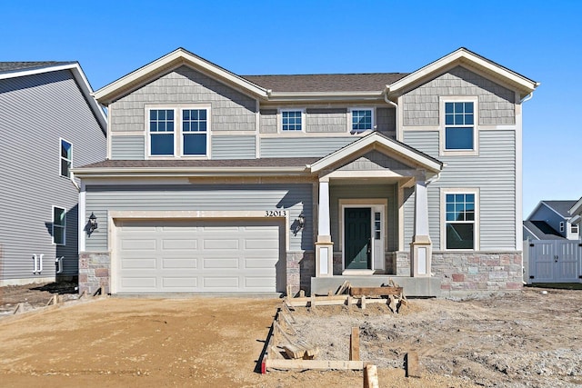 32013 Savannah Dr, Lakemoor, IL 60051 - view of front of home with an attached garage, driveway, and stone siding