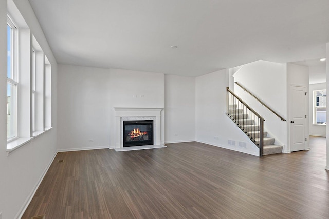 32013 Savannah Dr, Lakemoor, IL 60051 - unfurnished living room featuring stairway, baseboards, a high end fireplace, and dark wood-type flooring