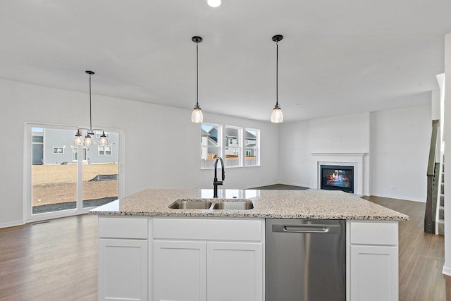 32013 Savannah Dr, Lakemoor, IL 60051 - kitchen with light stone counters, a sink, light wood finished floors, dishwasher, and a premium fireplace