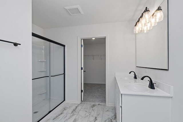 32013 Savannah Dr, Lakemoor, IL 60051 - bathroom featuring visible vents, a sink, marble finish floor, and a stall shower