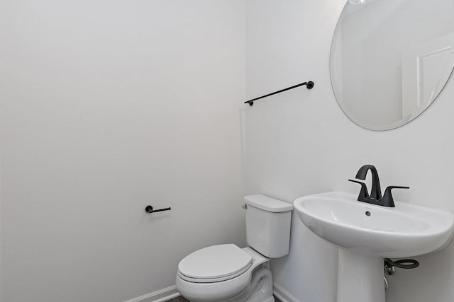 32013 Savannah Dr, Lakemoor, IL 60051 - half bathroom featuring a sink, baseboards, and toilet