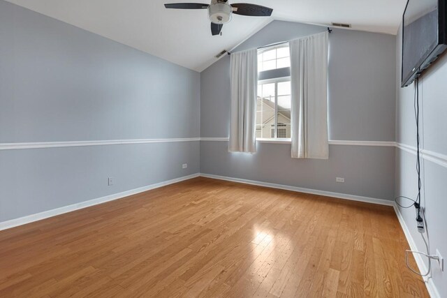 3412 Blue Ridge Dr, Carpentersville, IL 60110 - unfurnished room with light wood finished floors, a ceiling fan, vaulted ceiling, and baseboards