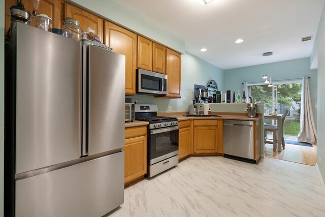3412 Blue Ridge Dr, Carpentersville, IL 60110 - kitchen featuring appliances with stainless steel finishes, a sink, light marble finish floors, recessed lighting, and a peninsula