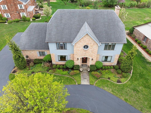 301 Hambletonian Dr, Oak Brook, IL 60523 - view of front facade with a chimney, brick siding, board and batten siding, and a front yard