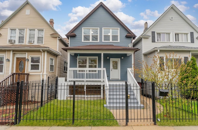 5052 W Huron St, Chicago, IL 60644 - view of front of home featuring covered porch, cooling unit, a fenced front yard, and a gate