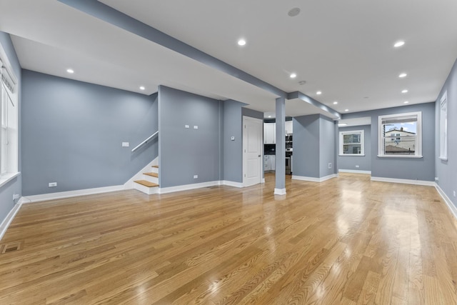 5052 W Huron St, Chicago, IL 60644 - unfurnished living room with visible vents, stairs, baseboards, recessed lighting, and light wood-style flooring