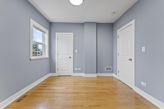5052 W Huron St, Chicago, IL 60644 - empty room with baseboards, light wood finished floors, and visible vents