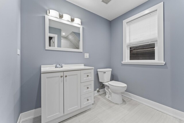 5052 W Huron St, Chicago, IL 60644 - bathroom with toilet, baseboards, and vanity