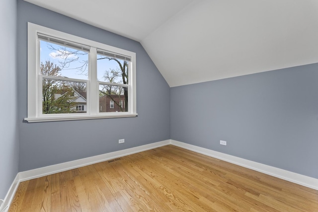 5052 W Huron St, Chicago, IL 60644 - additional living space with baseboards, visible vents, lofted ceiling, and light wood-type flooring