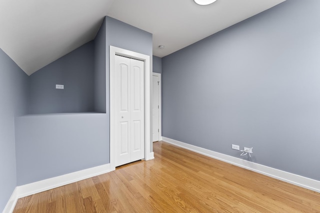 5052 W Huron St, Chicago, IL 60644 - additional living space with baseboards, vaulted ceiling, and light wood-type flooring