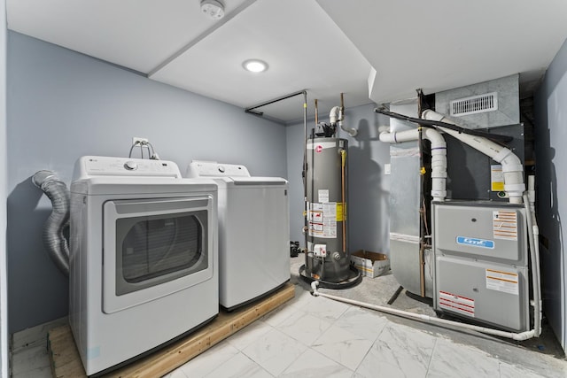 5052 W Huron St, Chicago, IL 60644 - laundry area featuring visible vents, laundry area, marble finish floor, washer and dryer, and water heater