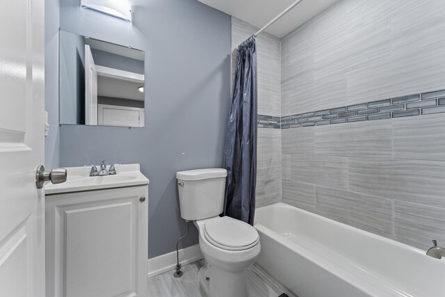 5052 W Huron St, Chicago, IL 60644 - full bathroom featuring baseboards, shower / bath combination with curtain, toilet, and vanity