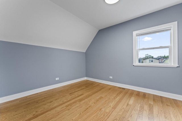 5052 W Huron St, Chicago, IL 60644 - bonus room with baseboards, vaulted ceiling, light wood finished floors, and visible vents