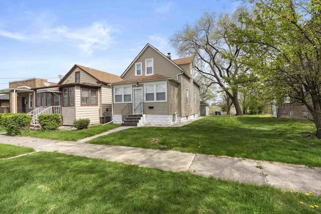 1319 Washington St, Chicago Heights, IL 60411 - view of front facade with entry steps, a chimney, and a front yard