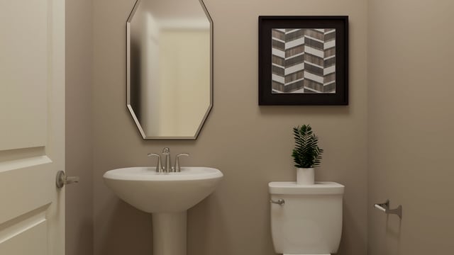 half bathroom with a sink and toilet