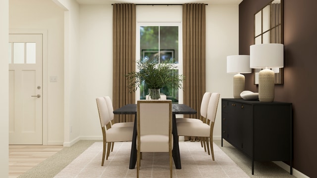 dining area featuring baseboards and plenty of natural light