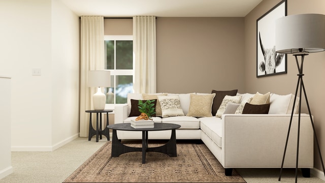 carpeted living area with baseboards