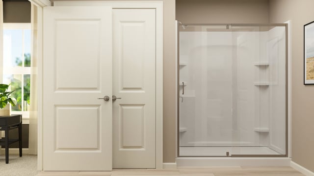 bathroom with baseboards and a shower stall