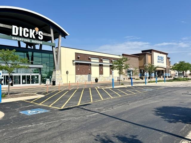 view of building exterior with uncovered parking