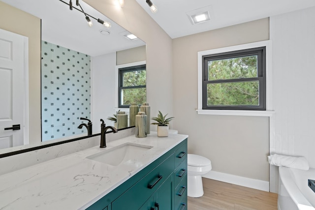 16 S Northampton Dr, Geneva, IL 60134 - bathroom with toilet, wood finished floors, vanity, a tub, and baseboards