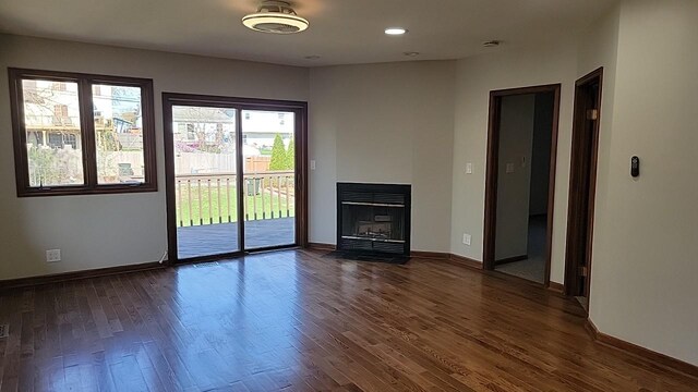 226 N Wilmette Ave, Westmont, IL 60559 - unfurnished living room with dark wood-style flooring, baseboards, a fireplace with flush hearth, and recessed lighting