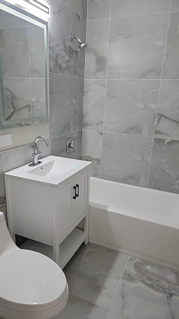 226 N Wilmette Ave, Westmont, IL 60559 - bathroom with vanity, marble finish floor, toilet, and shower / bathing tub combination