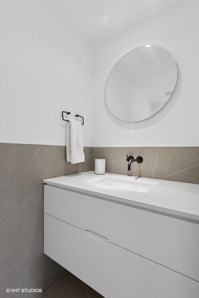 1917 S Calumet Ave, Chicago, IL 60616 - bathroom featuring tile walls, vanity, wainscoting, and tile patterned flooring