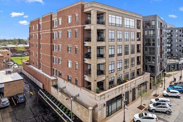 view of apartment building / complex featuring uncovered parking