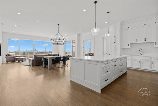 kitchen featuring dark wood-style flooring, a chandelier, white cabinets, recessed lighting, and light countertops