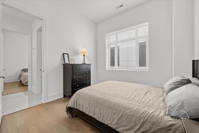 bedroom with wood finished floors and baseboards