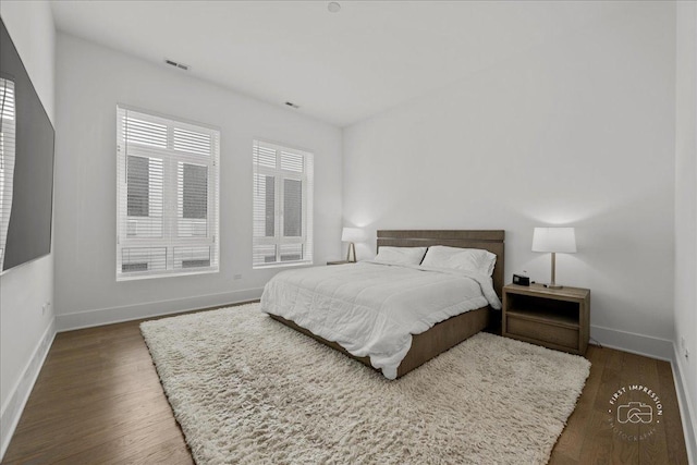 bedroom featuring wood finished floors and baseboards