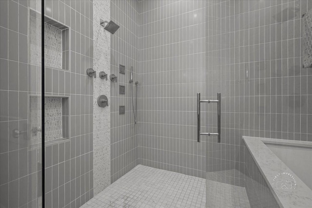 full bath featuring a tile shower