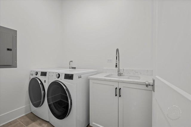 washroom featuring washer and dryer, electric panel, cabinet space, and baseboards