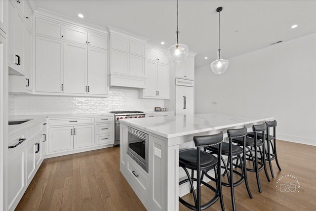 kitchen featuring built in appliances, recessed lighting, dark wood-style flooring, white cabinetry, and decorative backsplash