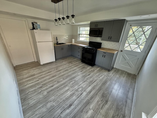 106 Kazwell St, Willow Springs, IL 60480 - kitchen featuring gray cabinets, freestanding refrigerator, black range with gas cooktop, a sink, and wood counters