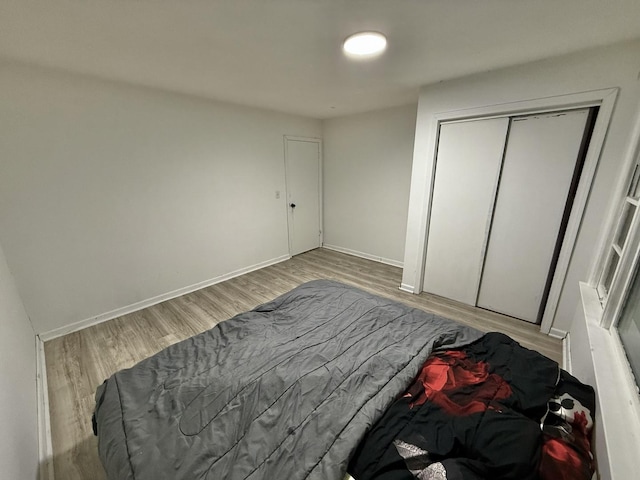 106 Kazwell St, Willow Springs, IL 60480 - bedroom featuring wood finished floors, a closet, and baseboards